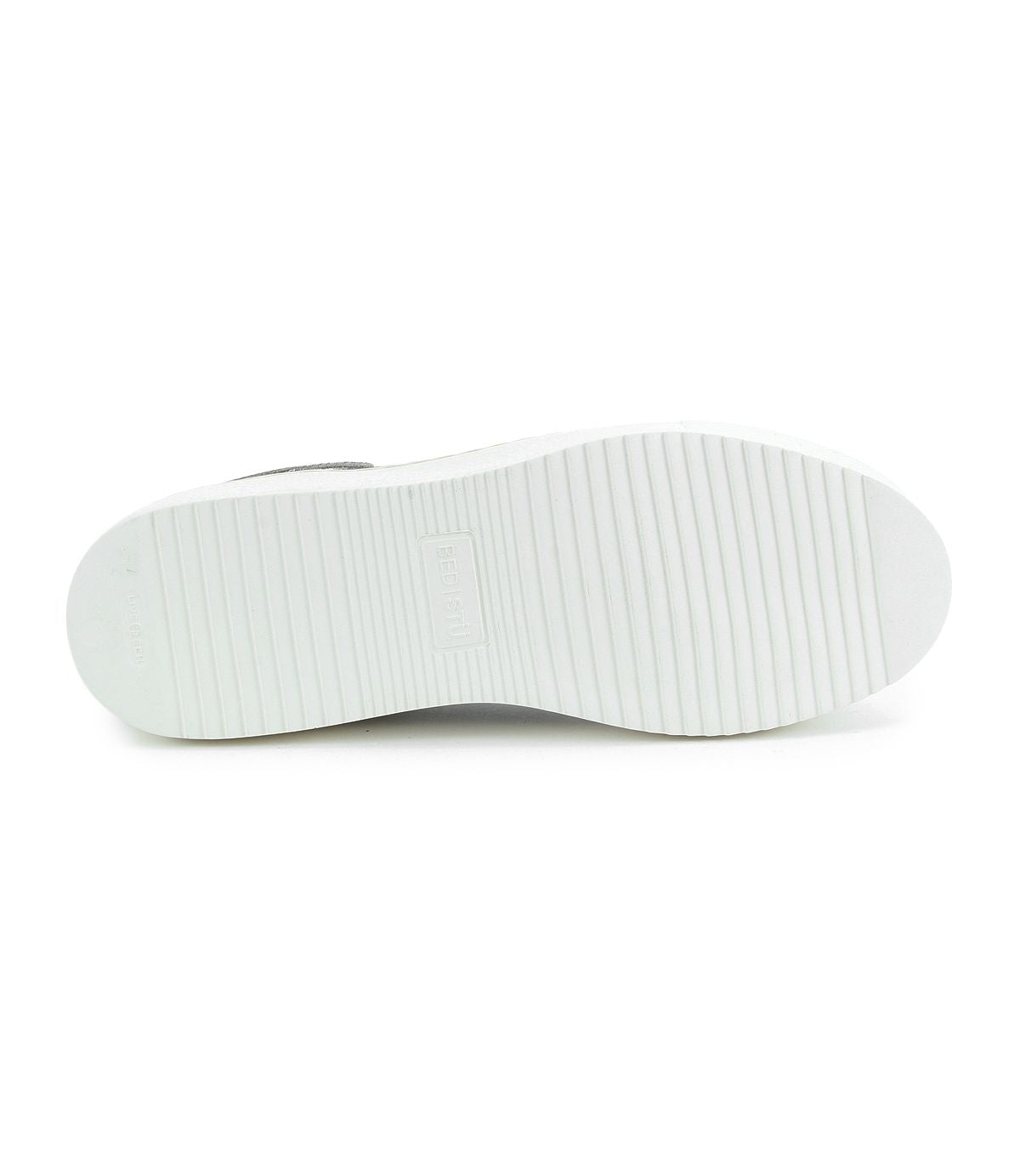 The image highlights the sole of a white leather sneaker with horizontal ridges and "Bed Stu" embossed in the center, embodying a modern style while maintaining its classic low-profile sneaker appeal, known as Azeli.