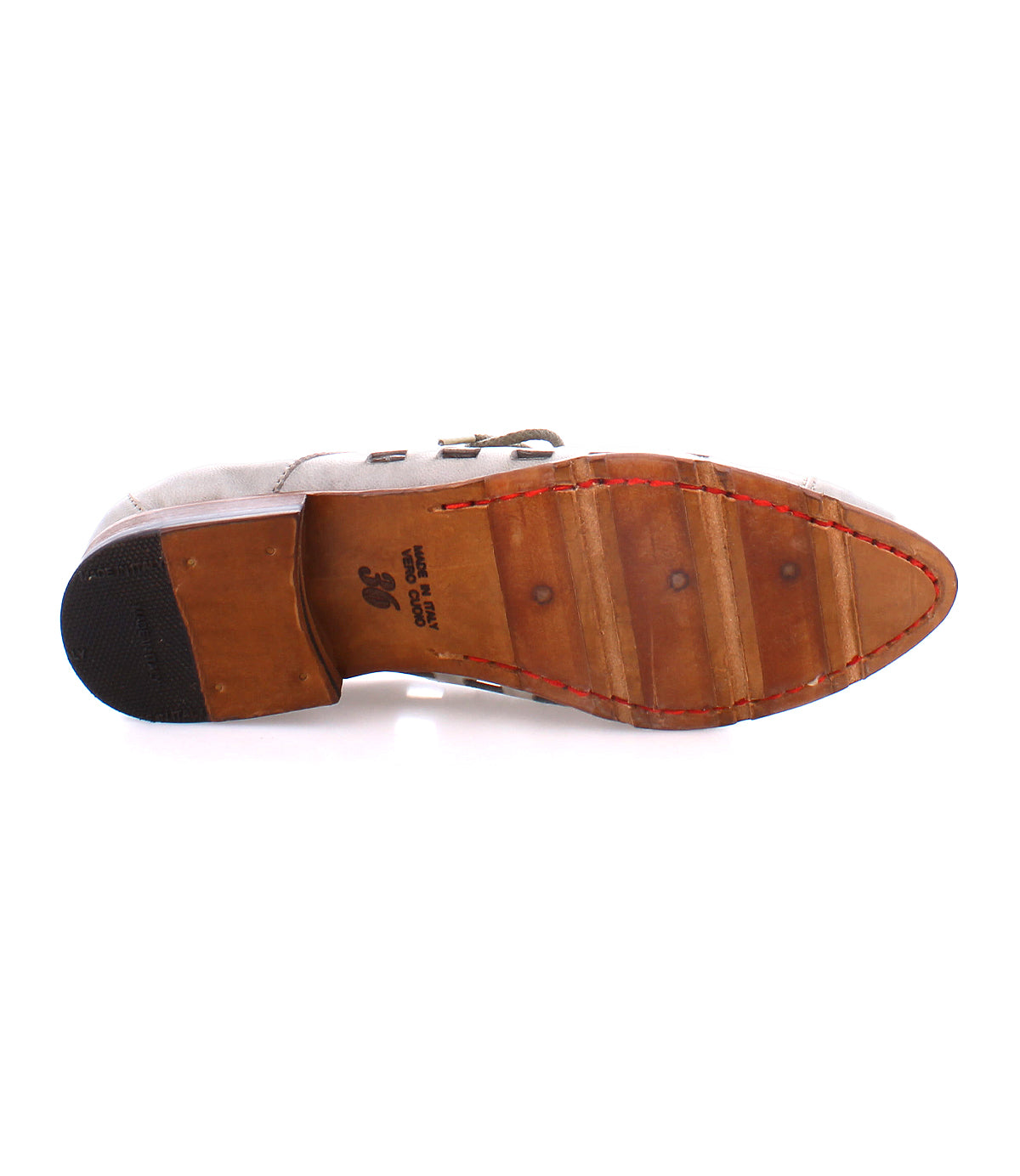 The underside of a handcrafted in Italy dress shoe shows a leather sole with a rubber heel cap and bold square cutouts, along with visible stitching along the edges. The size and manufacturing details are printed on the middle, featuring the Decoy by Bed Stu.