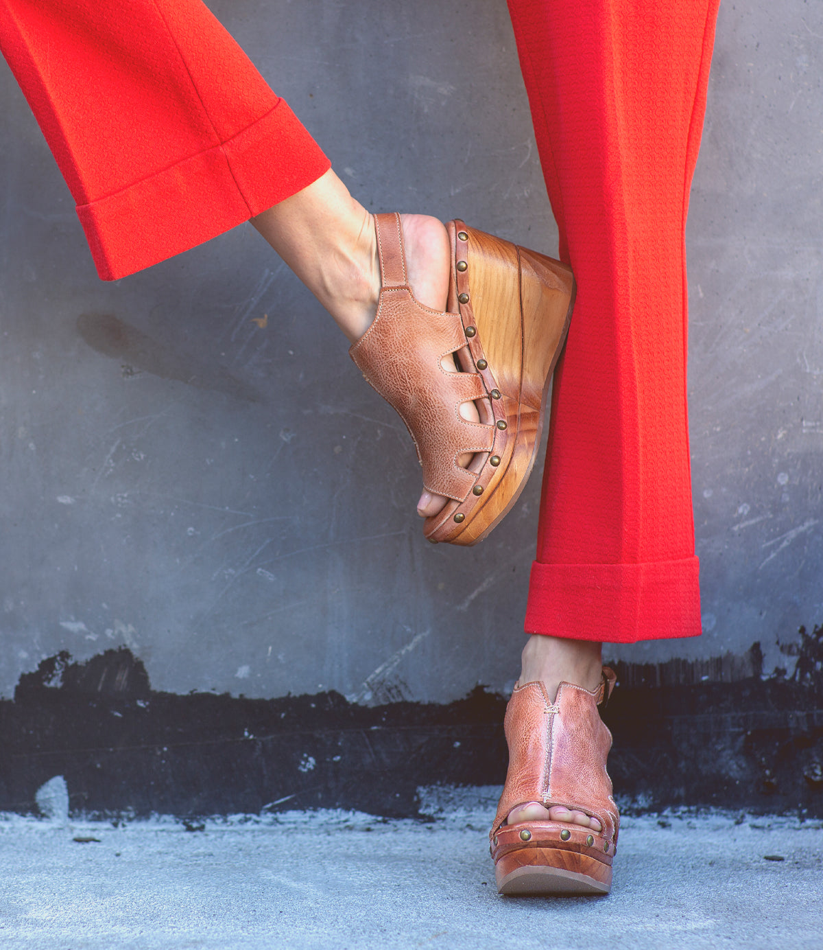 A woman wearing red pants and a pair of Naiya by Bed Stu, showcasing her eco-friendly fashion sense.