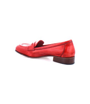 Red Italian leather penny loafer with a low brown heel and classic style penny slot detail on the top, viewed from the back side, named Paris by Bed Stu.