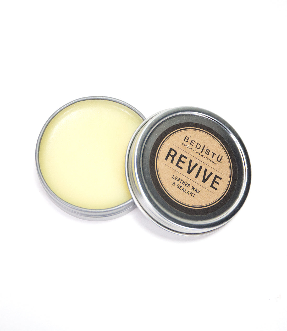 Open tin of Bed|Stü Revive Leather Care Package and wax sealant, displaying the yellowish wax against a white background.