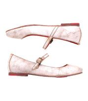 Two worn gold Mary Jane flats with red soles, one showcased from the side and the other from the top, featuring an adjustable strap. Perfect for channeling the ballerinacore trend. Introducing Shuffle III by Bed Stu.