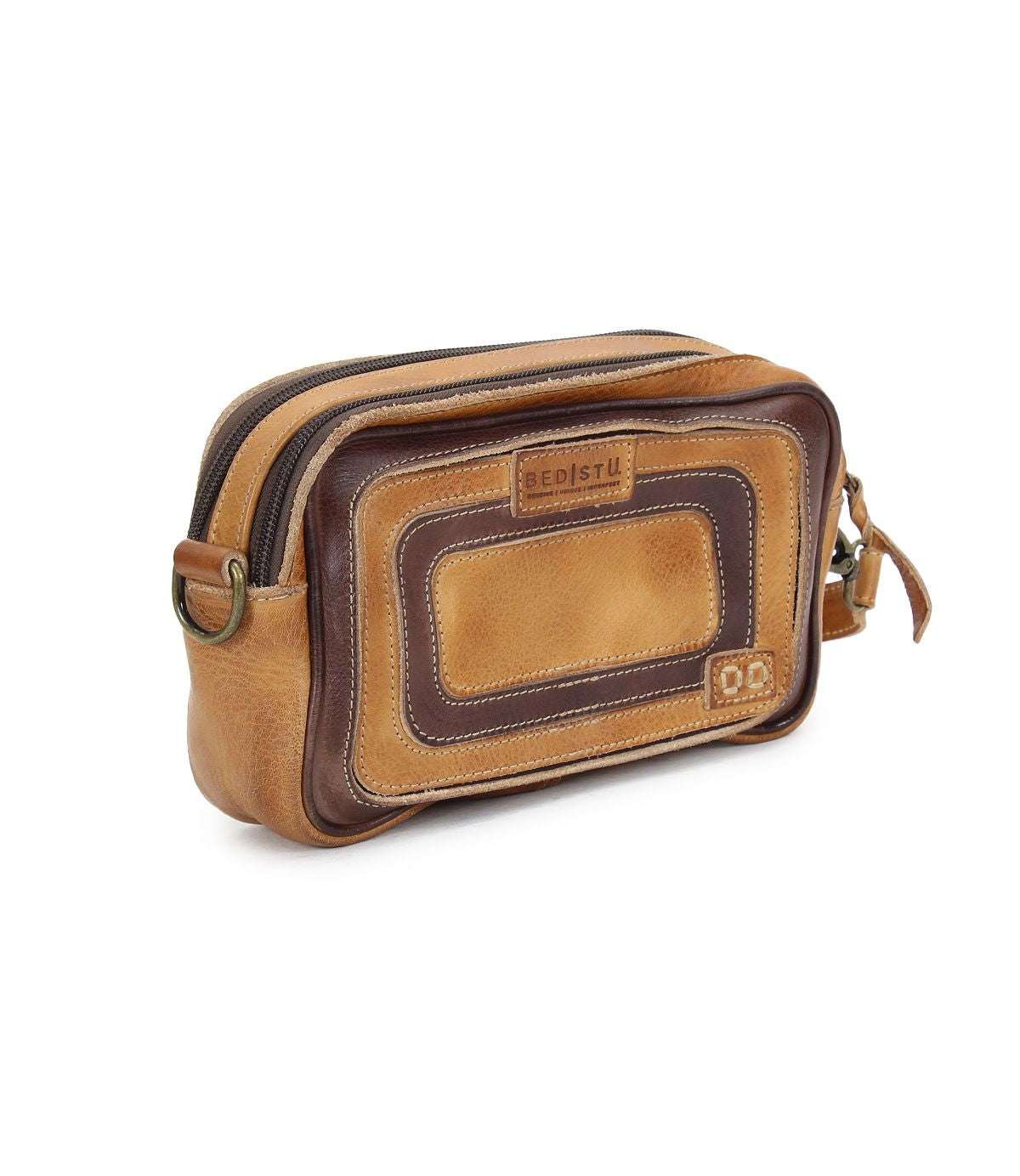 The Shy toiletry bag by Bed Stu is made from brown leather and features a zipper closure along with an organizational rectangular patch design on the front.