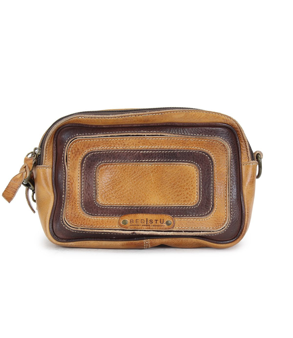 The "Shy" toiletry bag by Bed Stu is crafted from brown and tan leather and features a metal zipper and wrist strap, perfect for individuals who value organizational efficiency.