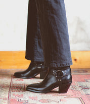 An Italian woman standing on a Vamoose rug wearing Bed Stu black leather boots.