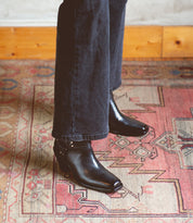 An Italian person standing on a Vamoose rug from Bed Stu.