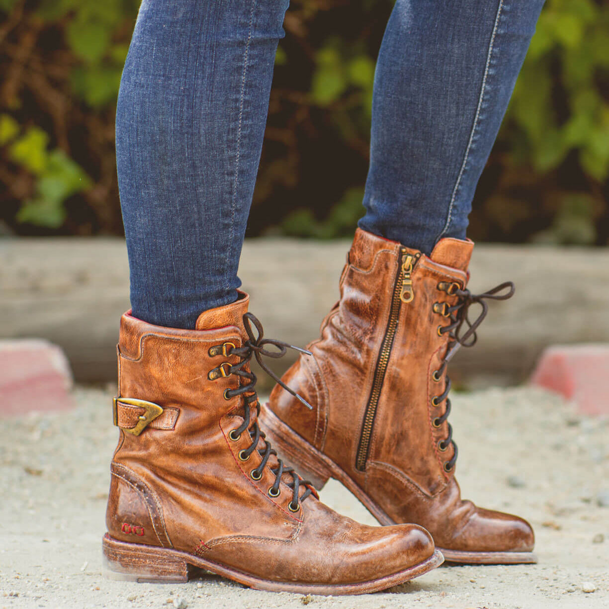 A woman's legs standing in a pair of Bed Stu Anne boots.