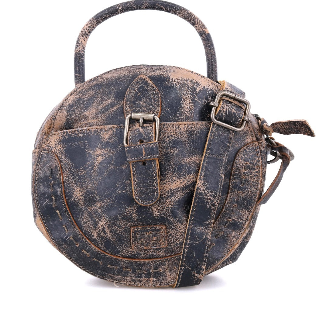 A round leather Arenfield bag with a strap and buckle, made by Bed Stu.