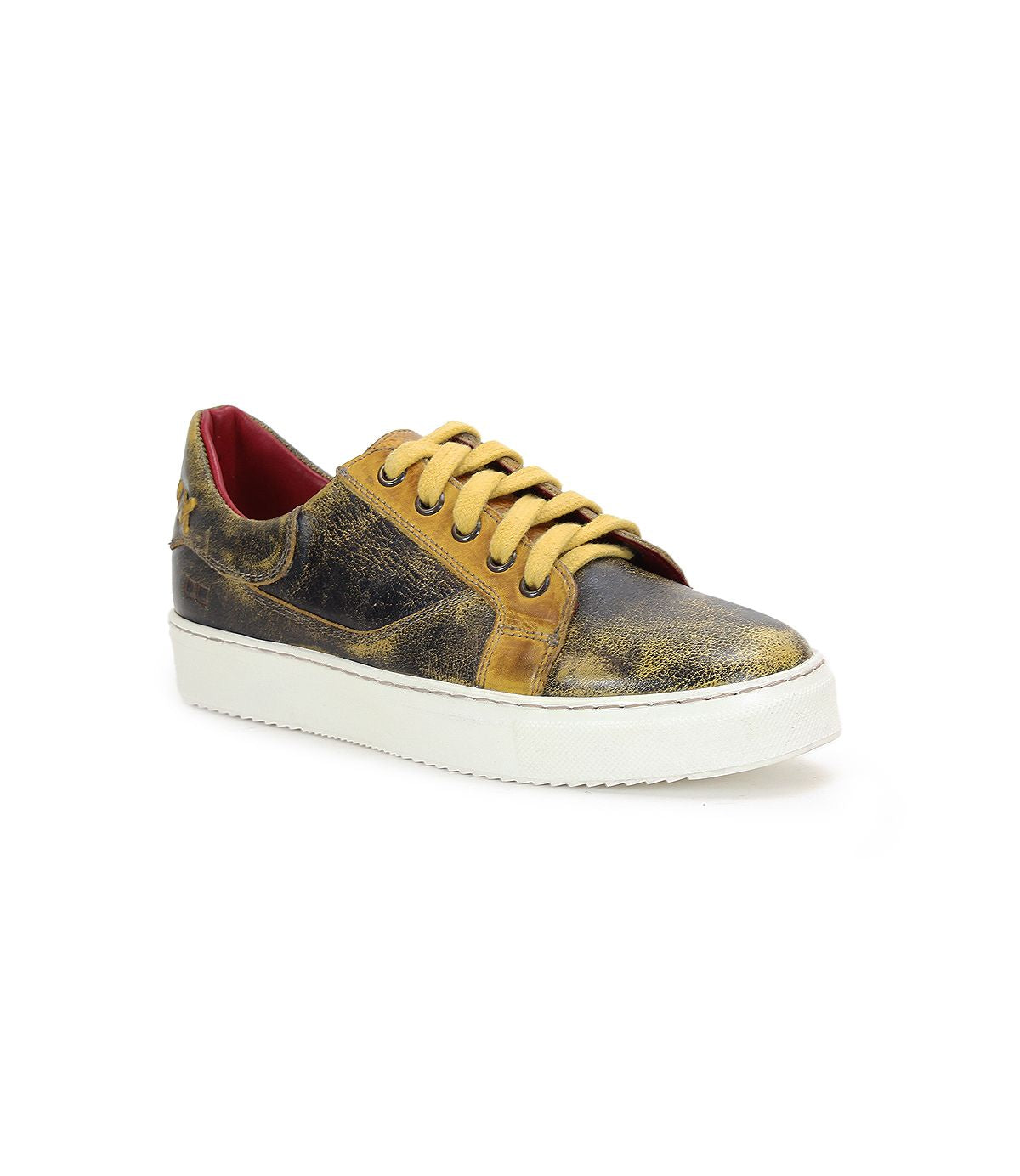 An Azeli sneaker by Bed Stu, featuring a worn yellow and black low-profile design with a durable white outsole, viewed from a slight angle.