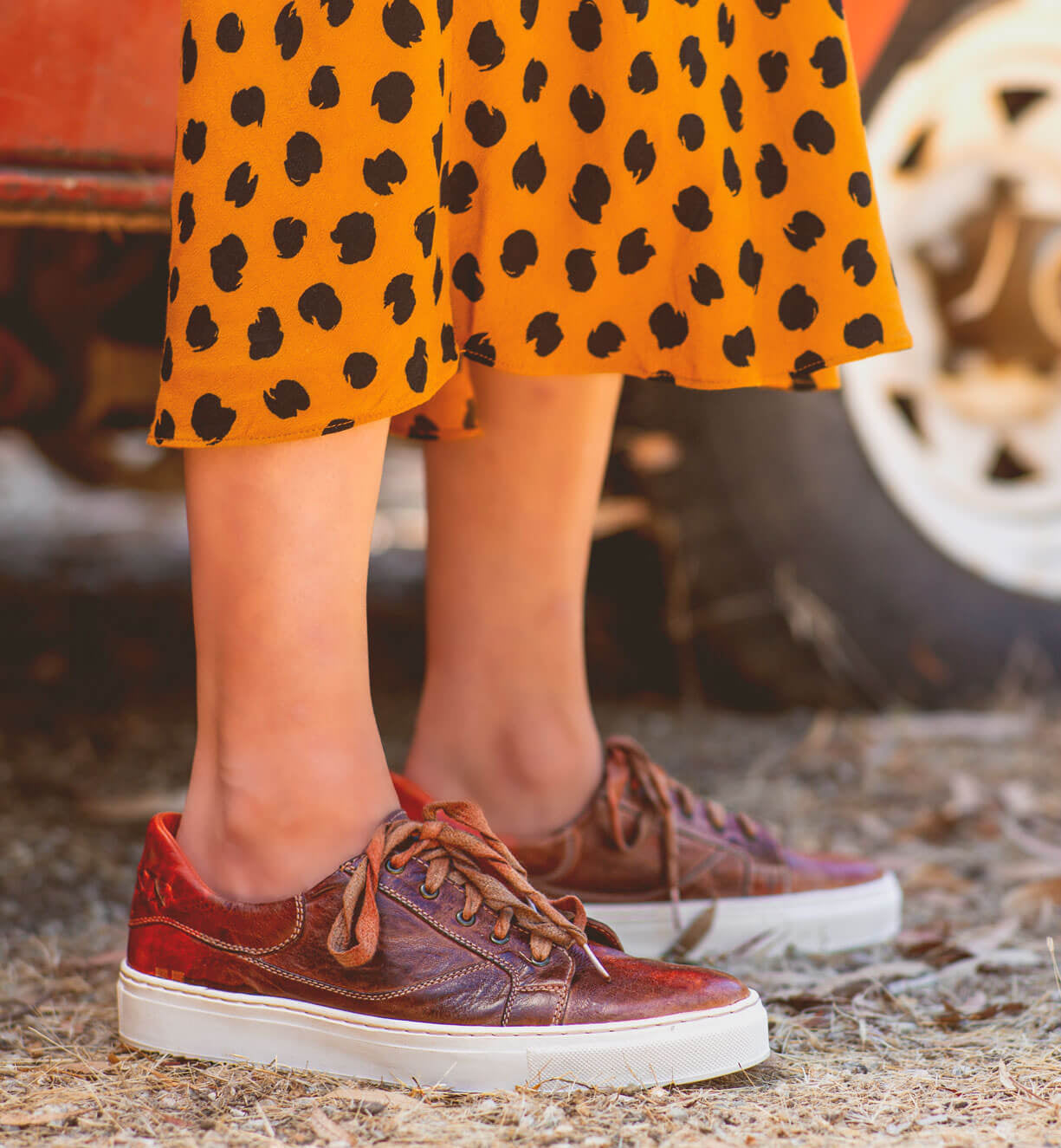 A woman wearing an Azeli dress and Bed Stu sneakers.