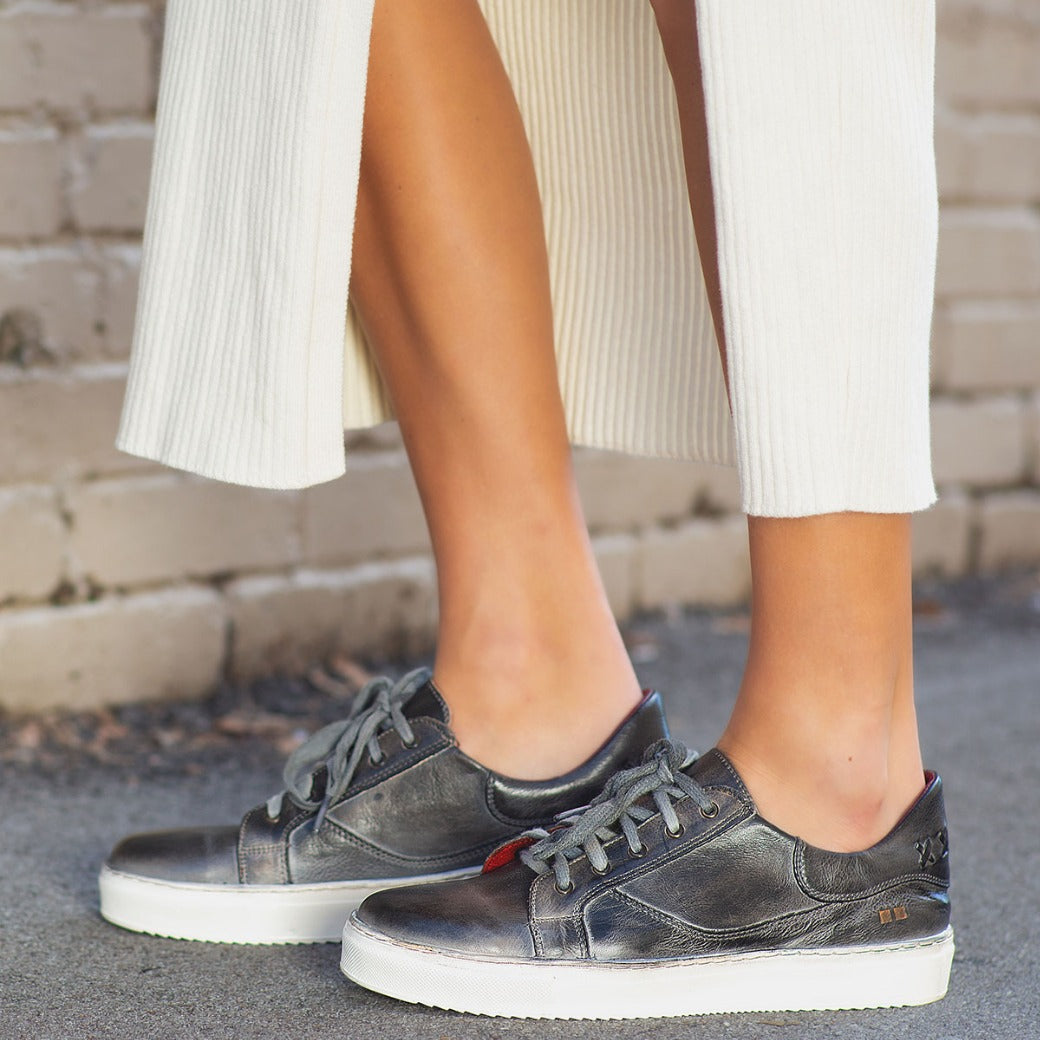 A woman wearing an Azeli skirt and Bed Stu sneakers.