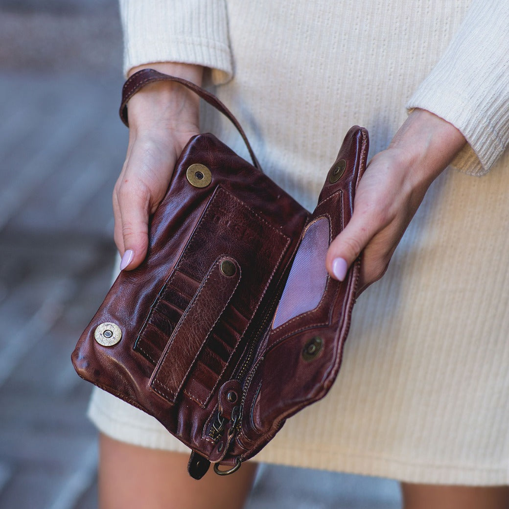 A woman holding a Bayshore wallet by Bed Stu.