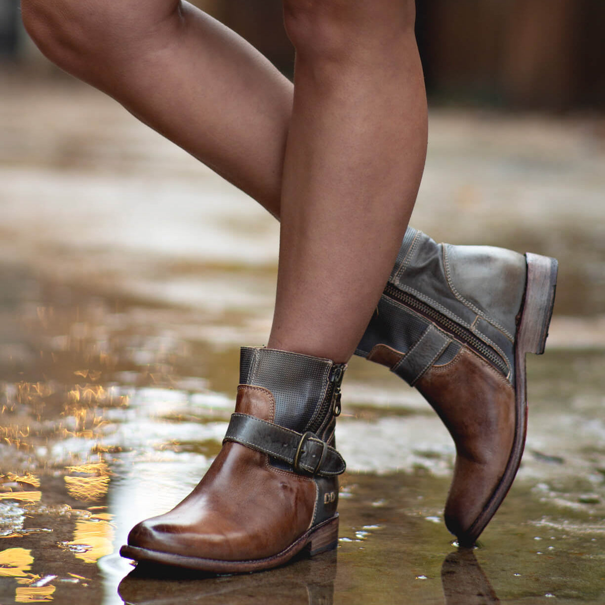 A woman wearing a pair of Bed Stu Becca taupe leather boots.