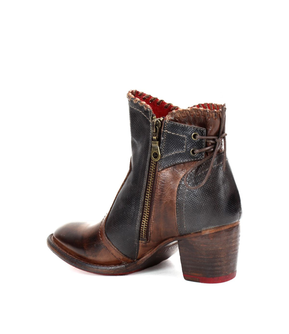 The Bia bootie by Bed Stu is a handcrafted brown and black leather shoe featuring a chunky heel, side zipper, and red inner lining, merging style with comfort.