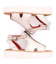 A pair of Clancy white leather sandal with white sole by Bed Stu.