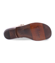 A sole product shot of a brown leather shoe for women made with Italian leather and has cutouts in a t-strap  type of shoe. 