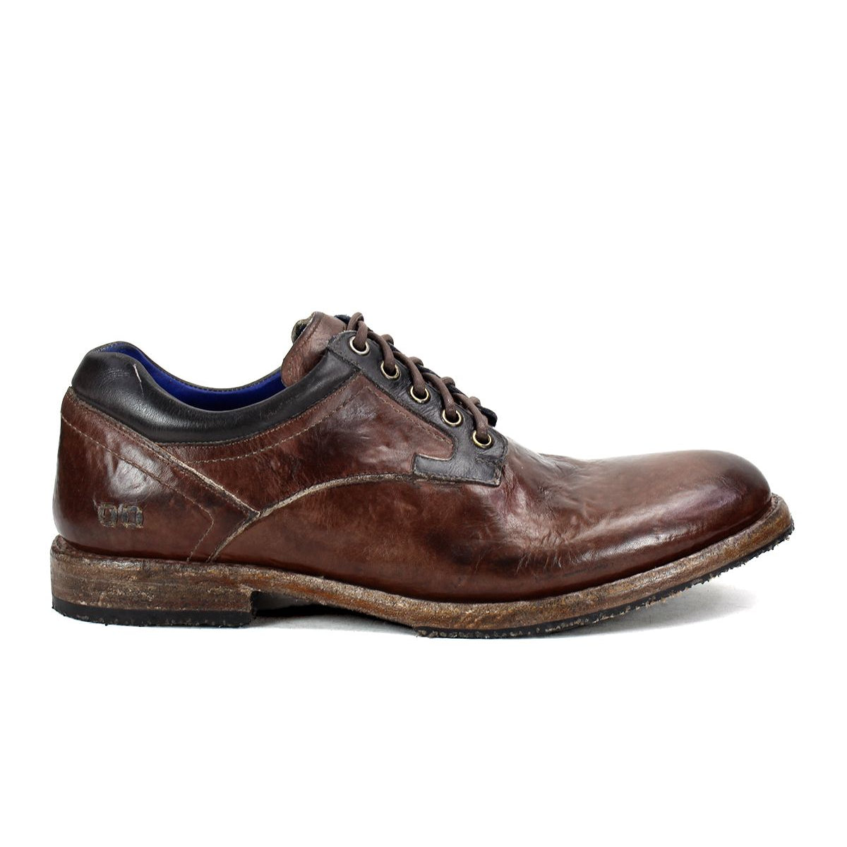 The Fierce by Bed Stu is a men's derby shoe featuring brown leather with a worn texture, lace-up closure, and a wooden sole, seamlessly blending classic design with modern flair.