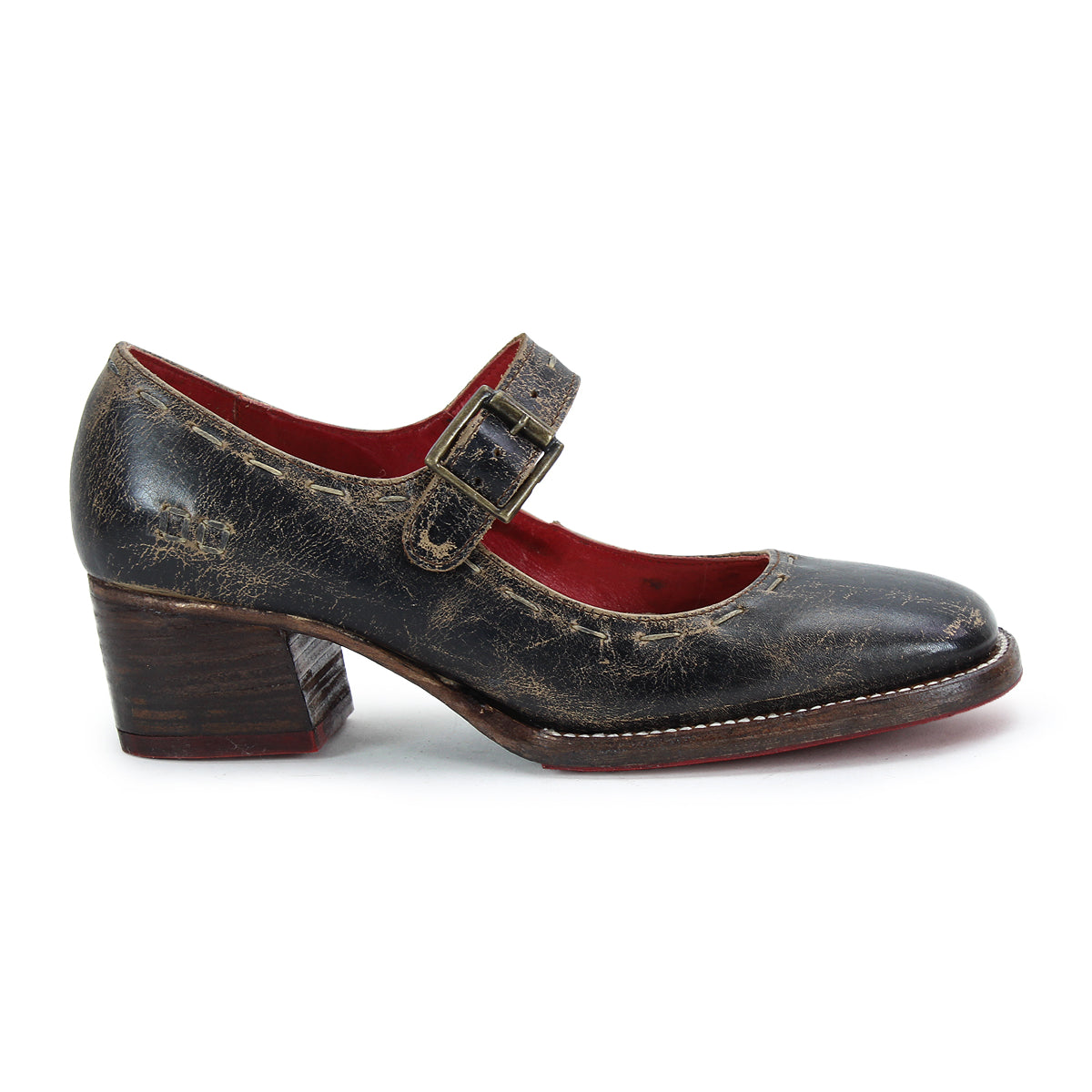 A worn, black leather Forefront by Bed Stu with an adjustable strap and buckle, comfortable heel, and red inner lining.