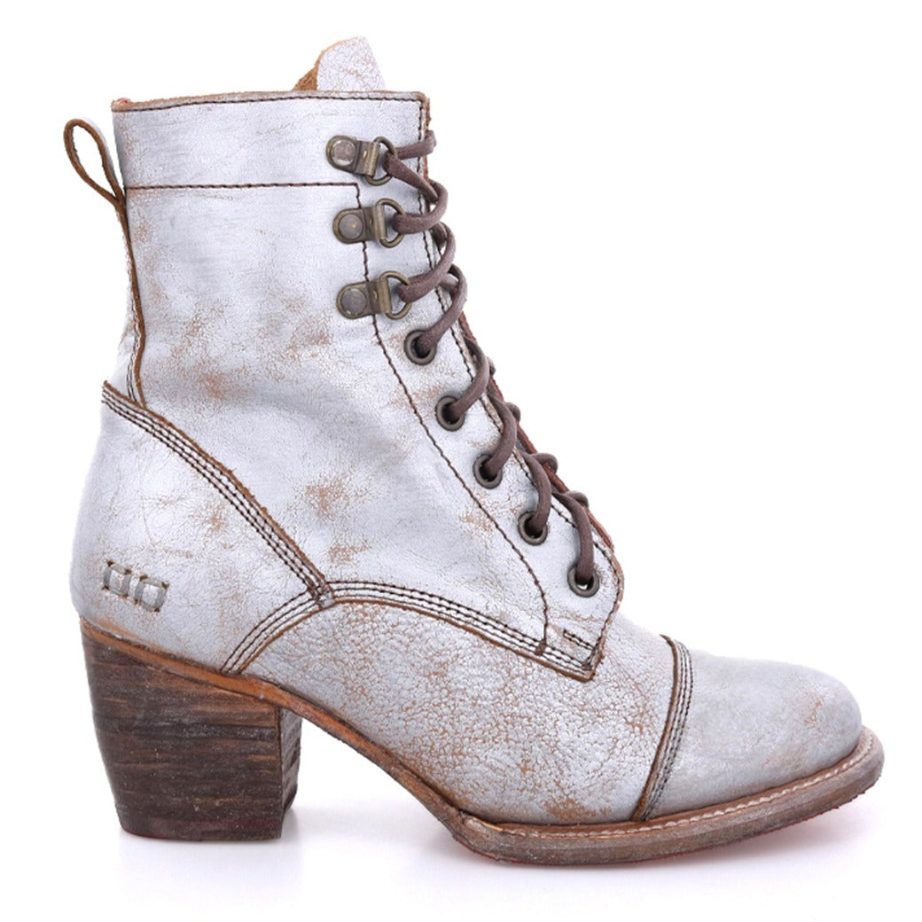 A women's silver ankle boot with a wooden heel, called Judgement by Bed Stu.