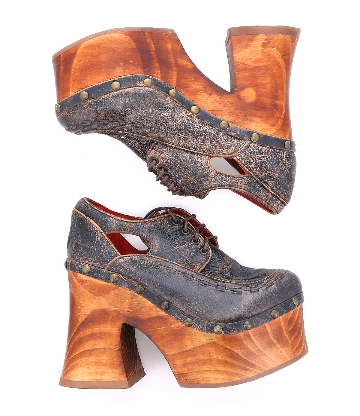 A pair of vintage 70s era platform shoes from Bed Stu, named Karaoke, featuring chunky wooden soles and heels, studded embellishments, and distressed brown leather uppers. The shoes boast an open arch design and lace-up fronts, making them perfect for a night out or as a unique choice for karaoke.