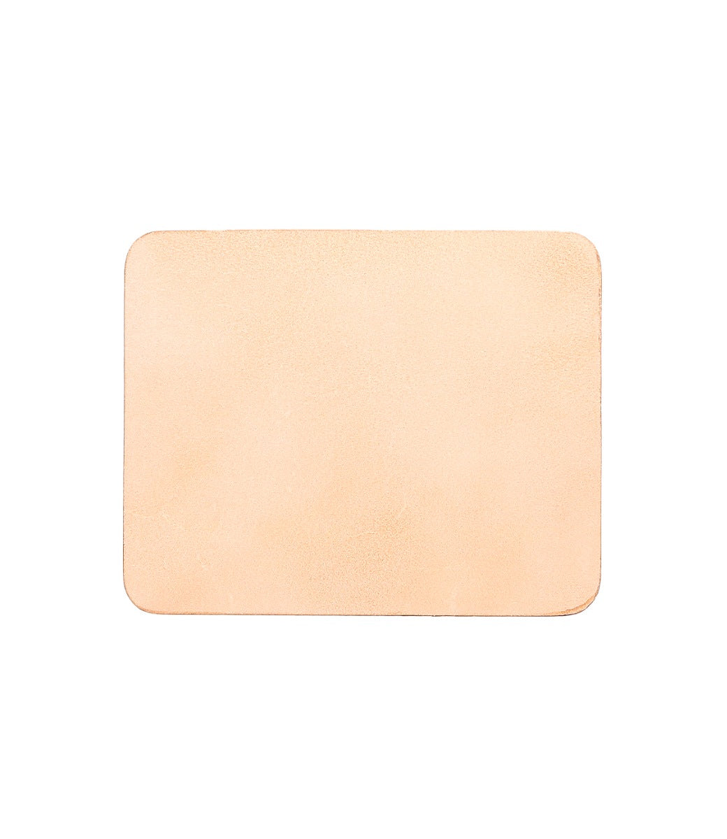 A Launcher Mouse Pad, rectangular, light tan-colored leather mouse pad with a suede underside and slightly rounded corners. Perfect for a curated workspace by Bed Stu.