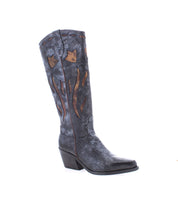 The Meadow from Bed Stu is a single, tall black leather cowgirl boot featuring a pointed toe, medium heel, and handcrafted decorative brown flame-patterned cutouts along the shaft.