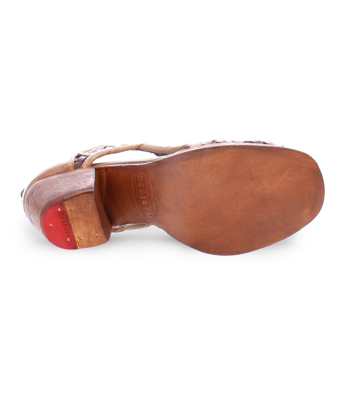 The image showcases the sole of the "Ransom" shoe, crafted from brown vegetable tanned leather, featuring a red rubber heel grip and the brand name "Bed Stu" engraved, illustrating exquisite artisan craftsmanship.