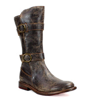 The Bed Stu Turn boot is a single short leather boot in brown, featuring adjustable buckle straps and a slightly worn appearance, crafted with Goodyear welted construction.