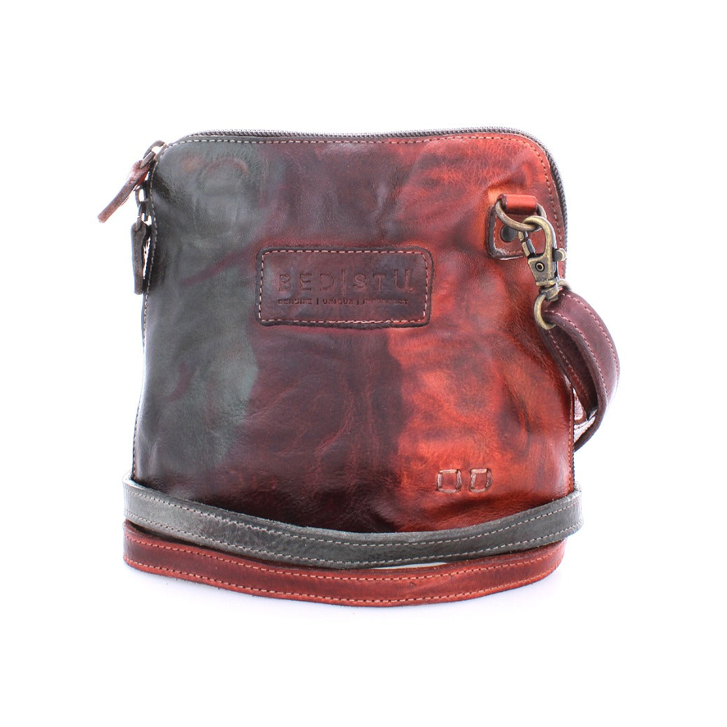 A red and black Ventura cross body bag with a zipper by Bed Stu.