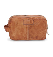 A Bed Stu Yatra brown leather toiletry bag on a white background.